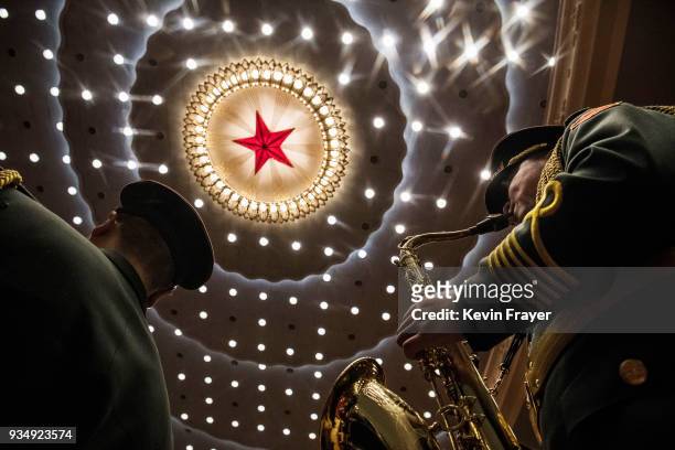 Members of a band from the People's Liberation Army play following a speech by China's President Xi Jinping during the closing session of the...