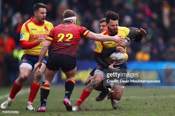 Charlie Malie of Spain is stopped by Thomas Wallraf and Vincent Hart of Belgium during the Rugby World Cup 2019 Europe Qualifier match between...
