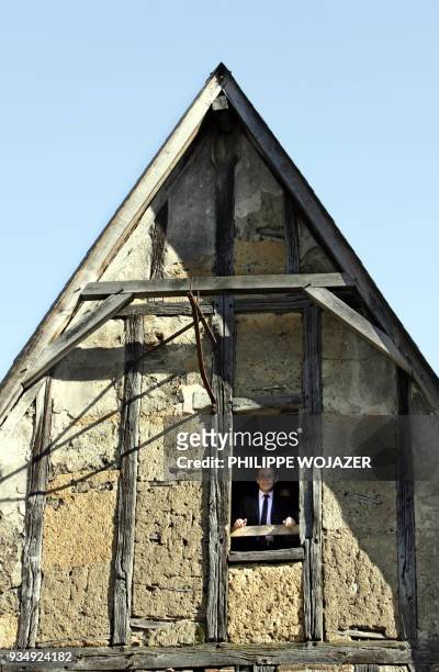French right-wing presidential candidate Nicolas Sarkozy appears at window of an old house of the 15th century which has been renoved by...