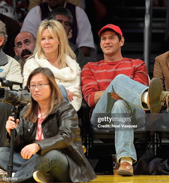 Heather Locklear and Thomas Calabro attend a game between the New Jersey Nets and the Los Angeles Lakers at Staples Center on November 29, 2009 in...