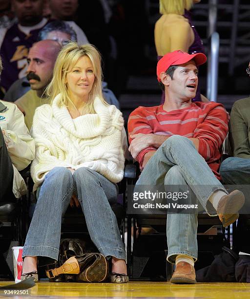 Heather Locklear and Thomas Calabro attend a game between the New Jersey Nets and the Los Angeles Lakers at Staples Center on November 29, 2009 in...