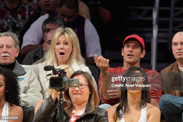 Heather Locklear and Thomas Calabro attend a game between the New Jersey Nets and the Los Angeles Lakers at Staples Center on November 29, 2009 in...