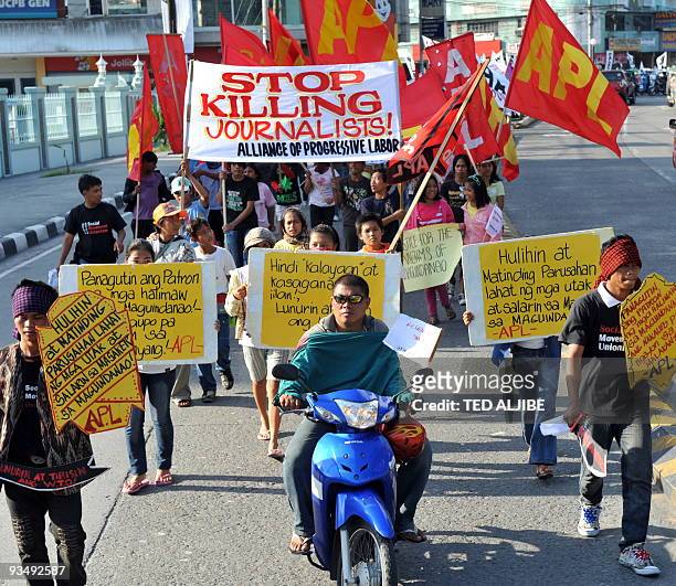 Residents march in the streets during a protest condemning the massacre of journalists in General Santos City, South Cotabato on November 30, 2009. A...