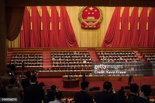 China's President Xi Jinping, bottom, speaks to the closing session of the National People's Congress at The Great Hall Of The People on March 20,...