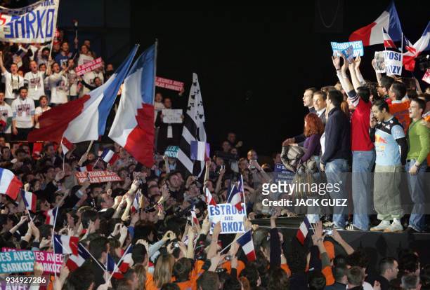 French right-wing presidential candidate Nicolas Sarkozy stands next to supporters at the end of a campaign meeting at the "Zenith" in Paris, 18...