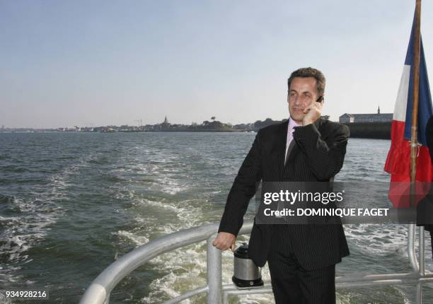 French right-wing presidential candidate Nicolas Sarkozy gives a phone call aboard a SNSM boat, French navy rescue unit, between Le Croisic and La...