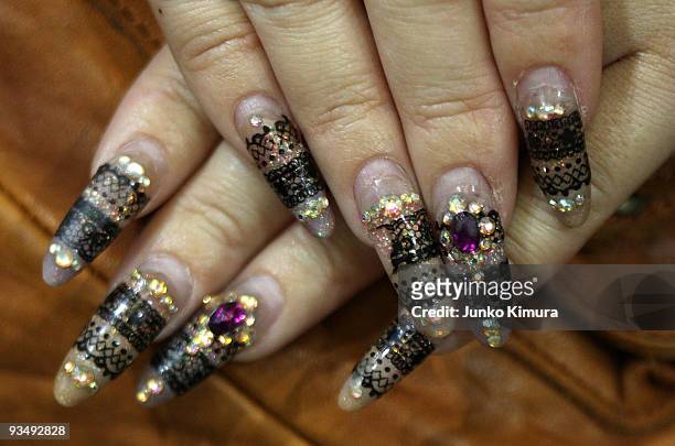 Visitor at Tokyo Nail Expo 2009 shows her nails at Tokyo Big Sight on November 30, 2009 in Tokyo, Japan. The nail industry has grown to nearly 200...