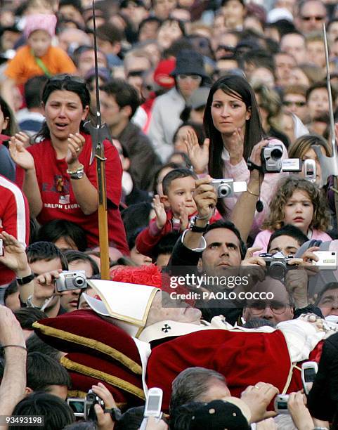 Pope John Paul II is carried to St. Peter's Basilica from the Apostolic Palace 04 April 2005 in the Vatican City. After the solemn procession the...