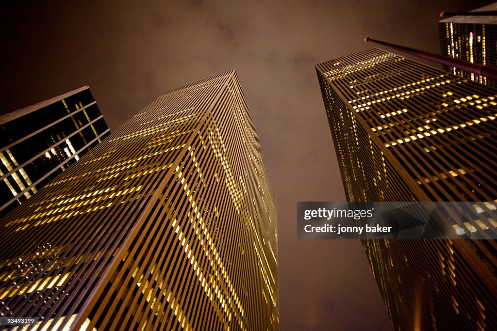 Looking up at new york skyscrapers at night