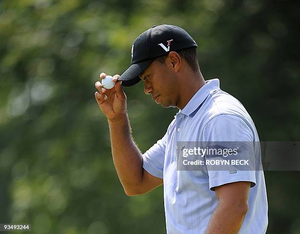 Tiger Woods of the US tips his cap after sinking a birdie putt on the second hole during the first round at the 91st PGA Championship at the...