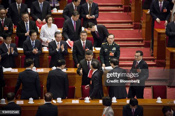 Xi Jinping, China's president, center, reaches out to shake hands with Zhang Gaoli, China's former vice premier, as Li Keqiang, China's premier,...