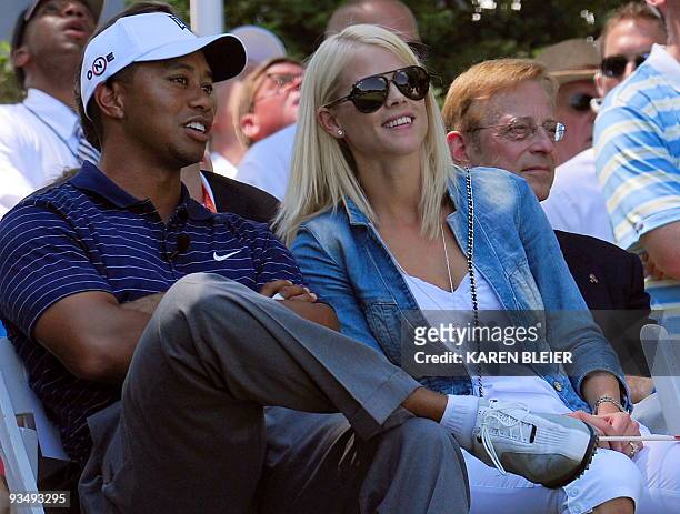 Tiger Woods of the US spekas with his wife Elin during ceremonies on July 1, 2009 at the AT&T National golf tournament hosted by Tiger Woods at the...