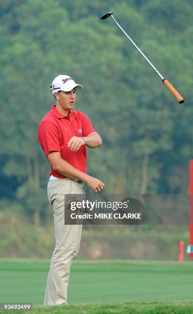 Swedens Henrik Stenson throws his club during the World Cup at Mission Hills in Southern China on November 29, 2009. Italy's Molinari brothers won...