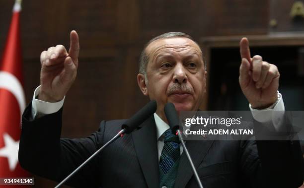 Turkish President and leader of the Justice and Development Party Recep Tayyip Erdogan gestures as he delivers a speech during the AK Party's...