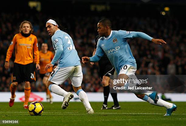 Carlos Tevez of Manchester City back heels the ball to Robinho during the Barclays Premier League match between Manchester City and Hull City at the...