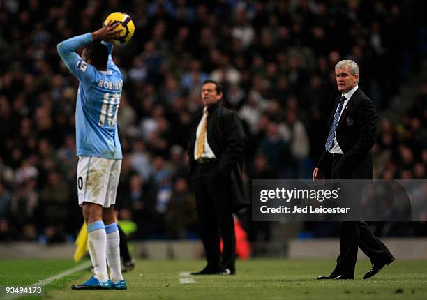Manchester City manager Mark Hughes watches Robinho take a throw in during the Barclays Premier League match between Manchester City and Hull City at...