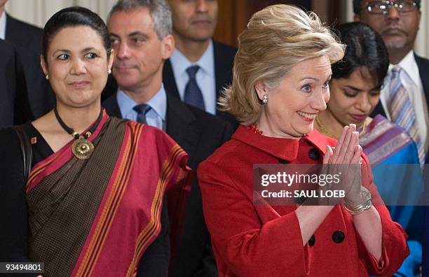 Secretary of State Hillary Clinton gestures alongside Meera Shankar , Indian Ambassador to the United States, during a state arrival hosted by US...