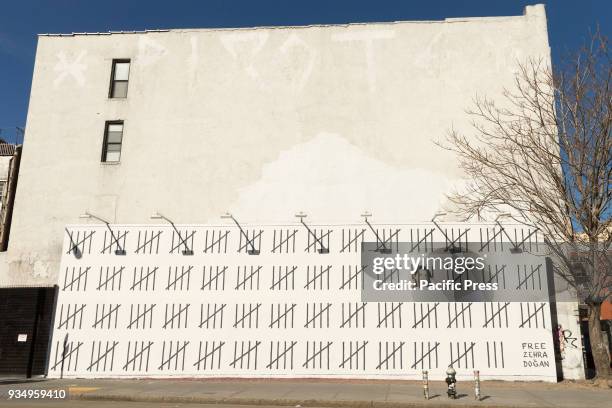 Mural painted by anonymous British street artist Banksy to protests imprisonment of Zehra Dogan of Turkey on East Houston street.