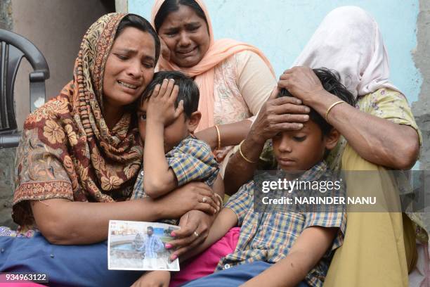 Indian resident Seema , her sons Karan and Arjun and her mother in-law Jeeto react following confirmation by External Affairs minister Sushma Swaraj...