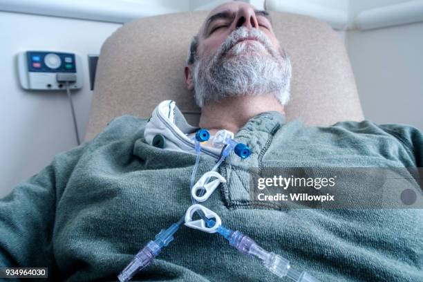cancer patient sleeping during outpatient chemotherapy - man sleeping with cap stock pictures, royalty-free photos & images