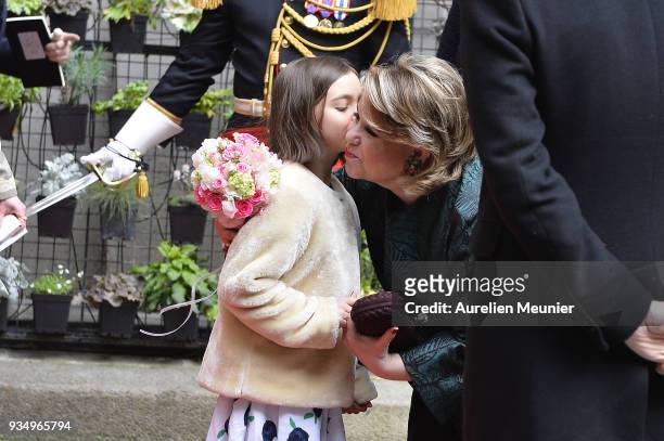 Maria Teresa, Grand Duchess of Luxembourg receives flowers from a little girl as Paris City Mayor Anne Hidalgo and French Minister of National...