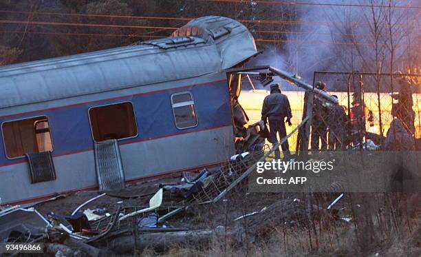 Police inspects a damaged railway carriage near the village of Uglovka in Russia's Novgorod region on November 28 as it derailed while traveling...