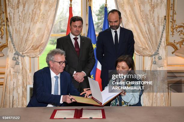 French Prime Minister Edouard Philippe and Luxembourg Prime Minister Xavier Bettel look at French Junior Minister for Economy Delphine Geny-Stephann...