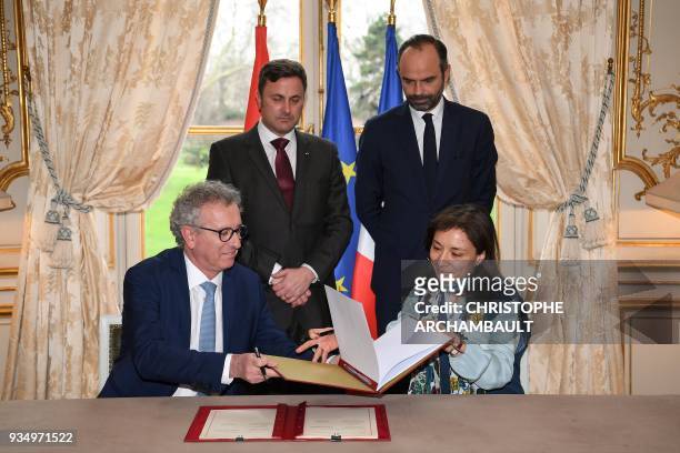 French Prime Minister Edouard Philippe and Luxembourg Prime Minister Xavier Bettel look at French Junior Minister for Economy Delphine Geny-Stephann...