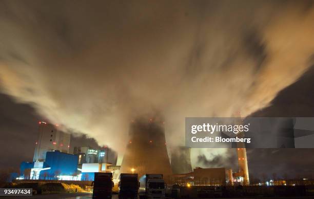 Smokestacks and cooling towers emit smoke and water vapor at the RWE AG owned coal-fired Niederaussem power station near Bergheim, Germany, on...