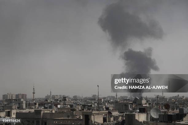 Smoke billows following Syrian government air strikes on the Eastern Ghouta rebel-held enclave of Douma, on the outskirts of the capital Damascus on...