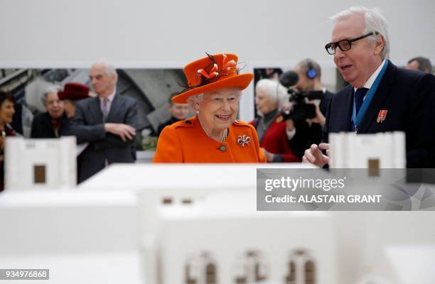 Britain's Queen Elizabeth II talks with British architect David Chipperfield as they look at a model of the Royal Academy of Arts building, during...