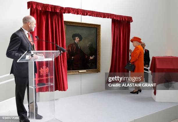 Britain's Queen Elizabeth II unveils a portrait of English painter Joshua Reynolds, painted by the artist himself, in a new gallery at the Royal...