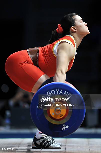 Cao Lei of China attempts a lift in the snatch of the women's 75kg category event at the World Weightlifting Championships in Goyang, north of Seoul,...