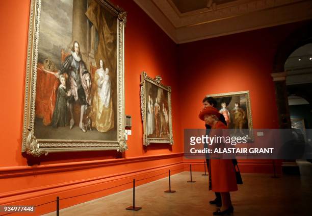 Britain's Queen Elizabeth II talks with curator Per Rumberg as she is shown paintings of King Charles I, during her visit to the Royal Academy of...
