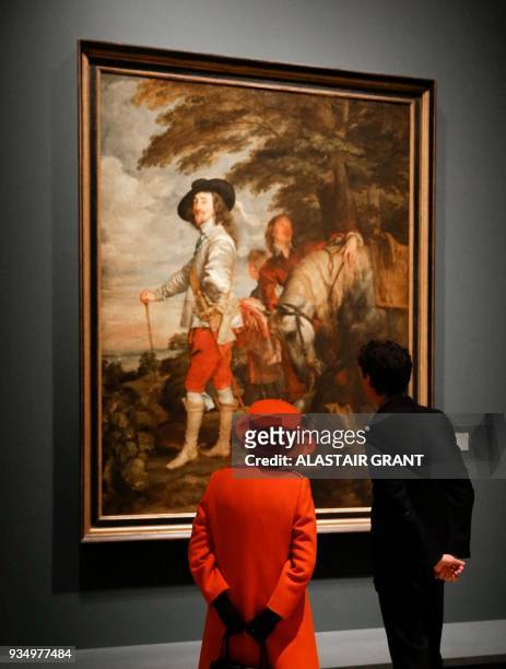 Britain's Queen Elizabeth II talks with curator Per Rumberg as she is shown paintings of King Charles I, during her visit to the Royal Academy of...