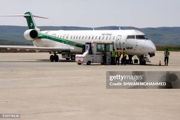 Picture taken on March 20, 2018 shows an Iraqi Airways Canadair CRJ-900 jet plane on the tarmac at the airport in the Iraqi Kurdish city of...