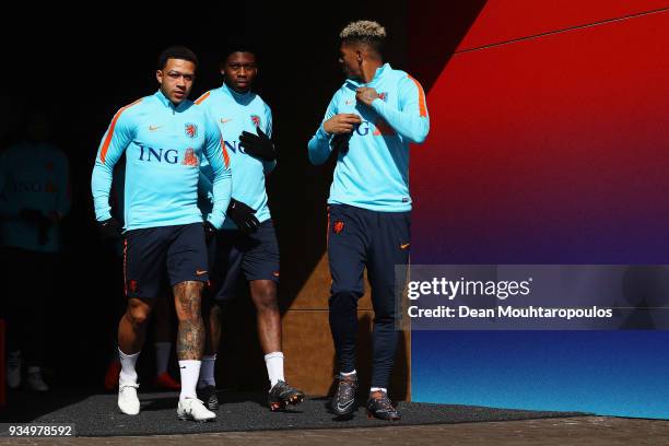 Memphis Depay, Timothy Fosu-Mensah and Patrick van Aanholt of the Netherlands walk out the players tunnel during the Netherlands Training session...