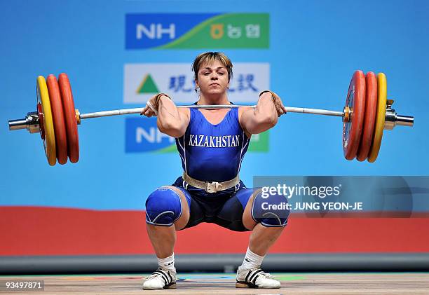 Svetiana Podobedova of Kazakhstan attempts a lift in the clean and jerk of the women's 75kg category event at the World Weightlifting Championships...