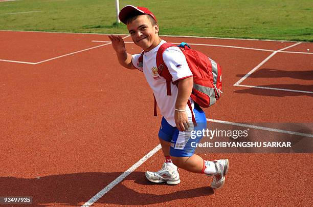 Physically challenged Russian athlete Dmitry Dushkin waves as he leaves the ground after competing in the F-40 class Shotput Men's 04 Kg event at the...