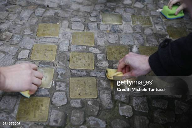 Berlin Schoolchildren participate in the spring cleaning of "Stolpersteine" memorials to Holocaust victims on March 20, 2018 in Berlin, Germany....