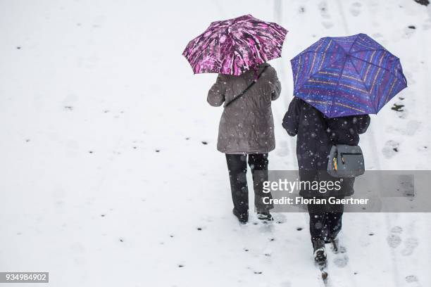 Two person walk during snow fall on March 20, 2018 in Berlin, Germany.