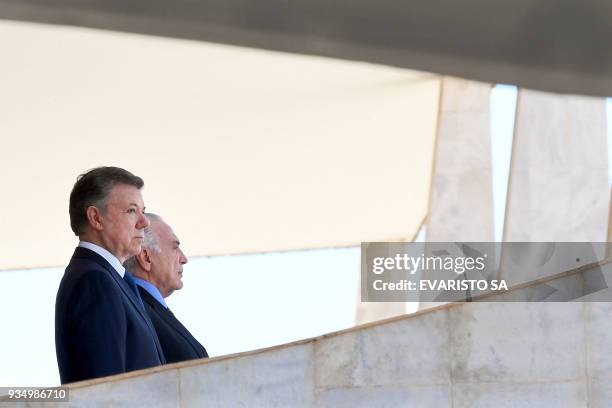 Colombia's President Juan Manuel Santos and Brazilian President Michel Temer listen to their national anthems during the former's welcoming ceremony...