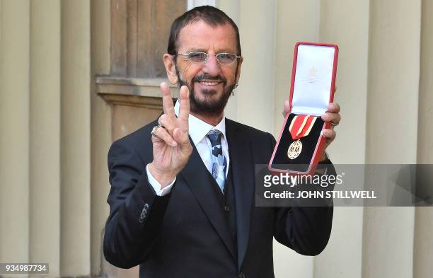 Richard Starkey, better knonwn as Ringo Starr, poses with his medal after being appointed Knight Commander of the Order of the British Empire at an...
