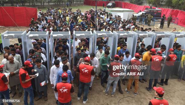 Pakistani cricket fans arrive and are searched ahead of the PSL T20 cricket match between Quetta Gladiators and Peshawar Zalmi teams at the Gaddafi...