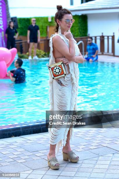 Natallia Lokun of New York wears a hand-woven dress from Tulum, Mexico with a bag from Morocco during the Behrouz & Friends Pool Party produced by...