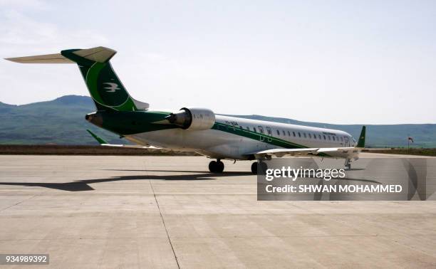 Picture taken on March 20, 2018 shows an Iraqi Airways Canadair CRJ-900 jet plane on the tarmac at the airport in the Iraqi Kurdish city of...