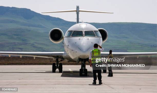 Picture taken on March 20, 2018 shows an Iraqi Airways Canadair CRJ-900 jet plane on the tarmac at the airport in the Iraqi Kurdish city of...