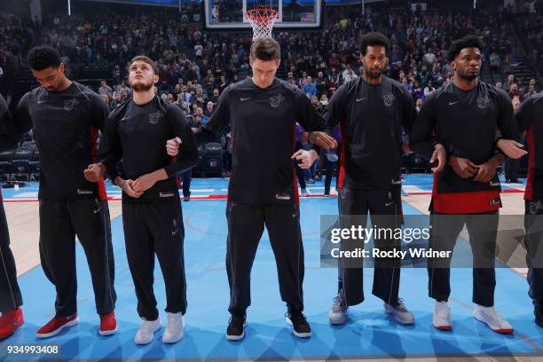 Luke Babbitt of the Miami Heat links arms up with teammates for the national anthem of the game against the Sacramento Kings on March 14, 2018 at...