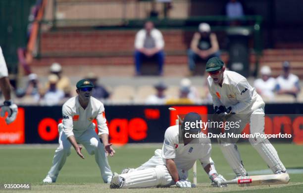 England batsman Robert Key falls over after attempting to sweep a ball from Shane Warne watched by slip fielder Damien Martyn and wicketkeeper Adam...