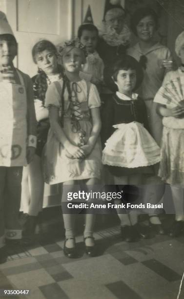 Sisters Anne and Margot Frank attend a children's party, circa 1934. Margot is on the third from the right, wearing a white apron, and Anne is in the...